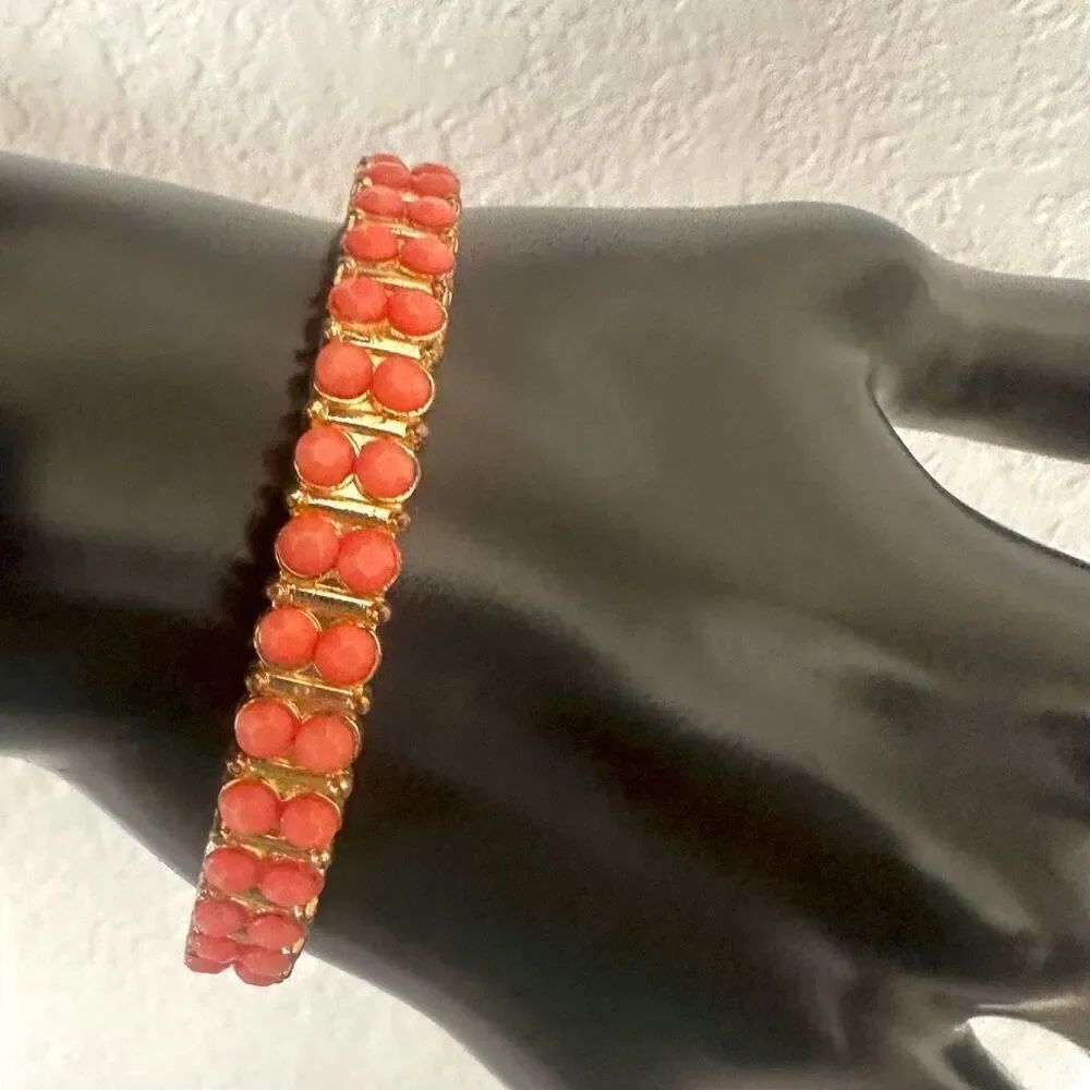 Peach beaded gold tone bangle bracelet